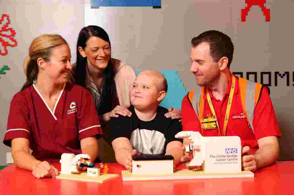 LEGOLAND® Discovery Centre Manchester has built a LEGO® model radiography machine which will be donated to help staff explain treatment to children at The Clatterbridge Cancer Centre.   Pictured Sarah Stead, Paediatric Specialist Radiographer at The Clatterbridge Cancer Centre, Reece Holt, a young patient who was treated with radiotherapy for a brain tumour at The Clatterbridge Cancer Centre, his Mum, Rachel O’Neill and Master Model Builder, Alex Bidolak, from LEGOLAND® Discovery Centre Manchester.  Picture: Jason Lock  Further info: Emma Portman Account Executive Emma.Portman@gough.co.uk> 01527 579555 www.gough.co.uk © Jason Lock Photography +44 (0) 7889 152747 +44 (0) 161 431 4012 info@jasonlock.co.uk www.jasonlock.co.uk