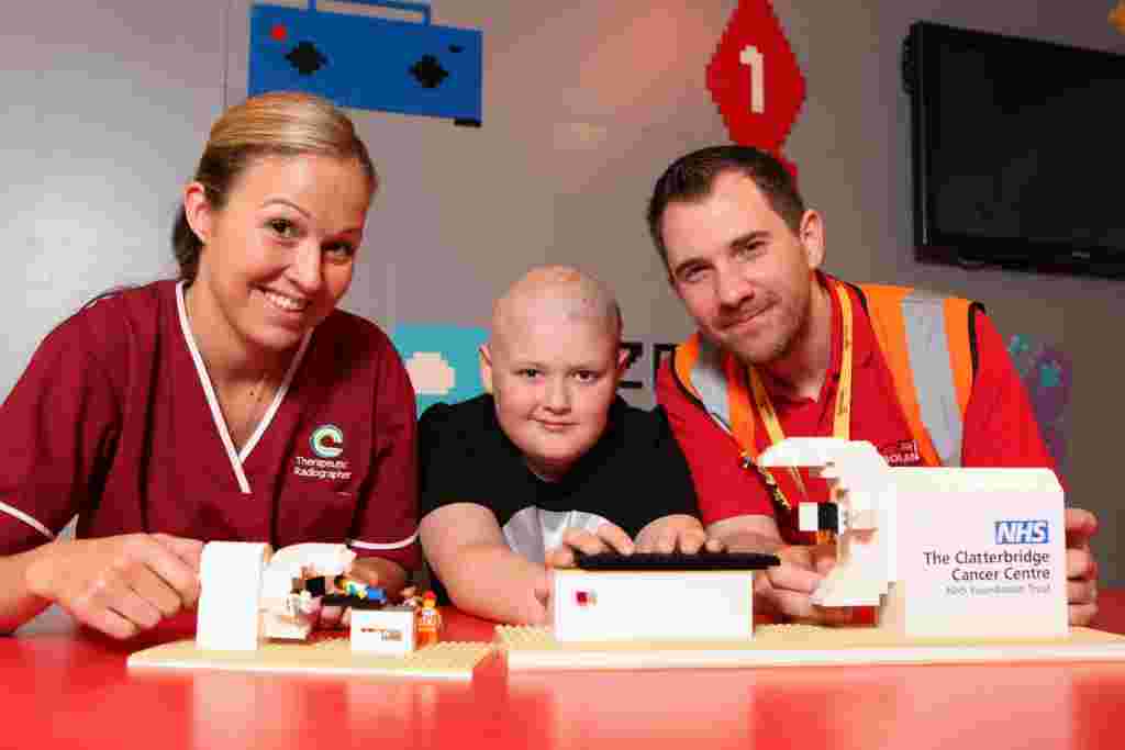 LEGOLAND® Discovery Centre Manchester has built a LEGO® model radiography machine which will be donated to help staff explain treatment to children at The Clatterbridge Cancer Centre.   Pictured Sarah Stead, Paediatric Specialist Radiographer at The Clatterbridge Cancer Centre, Reece Holt, a young patient who was treated with radiotherapy for a brain tumour at The Clatterbridge Cancer Centre, and Master Model Builder, Alex Bidolak, from LEGOLAND® Discovery Centre Manchester.  Picture: Jason Lock  Further info: Emma Portman Account Executive Emma.Portman@gough.co.uk> 01527 579555 www.gough.co.uk © Jason Lock Photography +44 (0) 7889 152747 +44 (0) 161 431 4012 info@jasonlock.co.uk www.jasonlock.co.uk