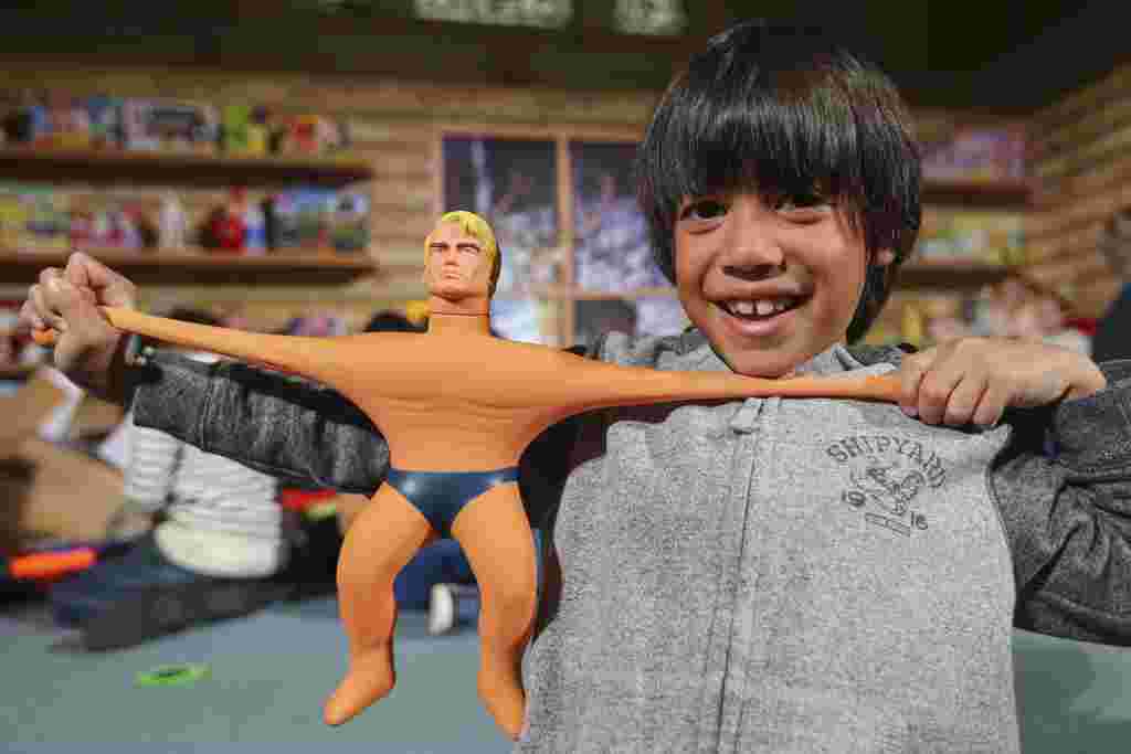 Thomas Laudriec with the new Stretch Armstrong toy at the Dreamtoys event at St Johns church, Central London, where the new hotly anticipated toys this Christmas are showcased.  November 9 2016. See National News story NNSTRETCH; A stretchy doll is set to become one of this year's must have Christmas toys - despite it looking like DONALD TRUMP. Stretch Armstrong, the iconic American body-builder hero, will be a familiar sight in many British homes this Christmas, just like the incoming US President. The popular action figure can survive being stretched up to four times his original size and being tied up in knots, a feeling Trump has become accustomed to during his gritty campaign to become the 45th President. The £19.99 doll sports a striking resemblance to the new President, as they both have an immovable blond hairdo, thick eyebrows and a square jaw.