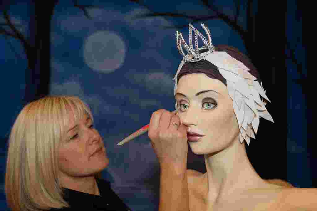 Emma Jayne Morris creator of  Swan Lake cake putting finishing touches on the cake at Cake International show at NEC Birmingham.  November 5, 2016.  A self-taught baker has created a stunning life-sized model of Swan Lake - using tens of thousands of RICE KRISPIES.  Talented Emma Morris, 46, spent eight days baking and icing a 2ft-high swan - complete with a 5ft 4in model ballerina.  The delicious designs, which are entirely edible, are made from 80kg (1,76lb) of Rice Krispies, 30kg (66lb) of sugar paste and 30kg (66lb) of modelling paste.  The impressive swan, which has a wing-span of 1m (3ft 2in), and the human-sized ballerina are also embellished with over 500 crystals.  The tasty treats are made of Rice Krispies instead of cake, in order to preserve them - and Emma still has a 4ft Avatar she created two years ago in her living room.  The model of Swan Lake's Odette is one of hundreds of creations at this year's Cake International display Birmingham's NEC.  The show is billed by organisers as the UK's biggest, with up to 30,000 visitors expected.  The mum-of-four, who runs Emma Jayne Cake Design in Aberdare, South Wales, thought of the design after a visit to Ireland when she saw swans gliding across a lake. Other creations on show include Gene Wilder in his most famous role as Willy Wonka, Dolly Parton and Vincent Van Gogh.