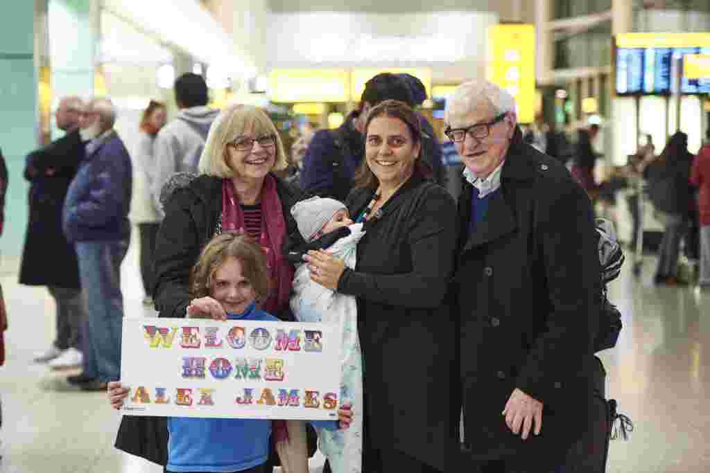 Heathrow Terminal 2, Tuesday 6th December, 2016: Loving parents greet their daughter and two grand children Alex and James on their return from Australia with welcome home banner at Heathrow Terminal 2  This Christmas, Heathrow is giving every passenger the chance to have their own heartfelt reunion in arrivals just as teddy bears Doris and Edward* did in their Christmas film. To celebrate those tender moments, the airport has partnered with prolific London-based street artist, Ben Eine, to create a range of personalised banners, for family and friends to make greeting their loved ones extra special this year. PR Handout - free for editorial usage. For more information, an interview with Ben Eine or further images please contact Emily.Stallard@onegreenbean.com/ 0207 467 9246.  Copyright: © Mikael Buck / Heathrow
