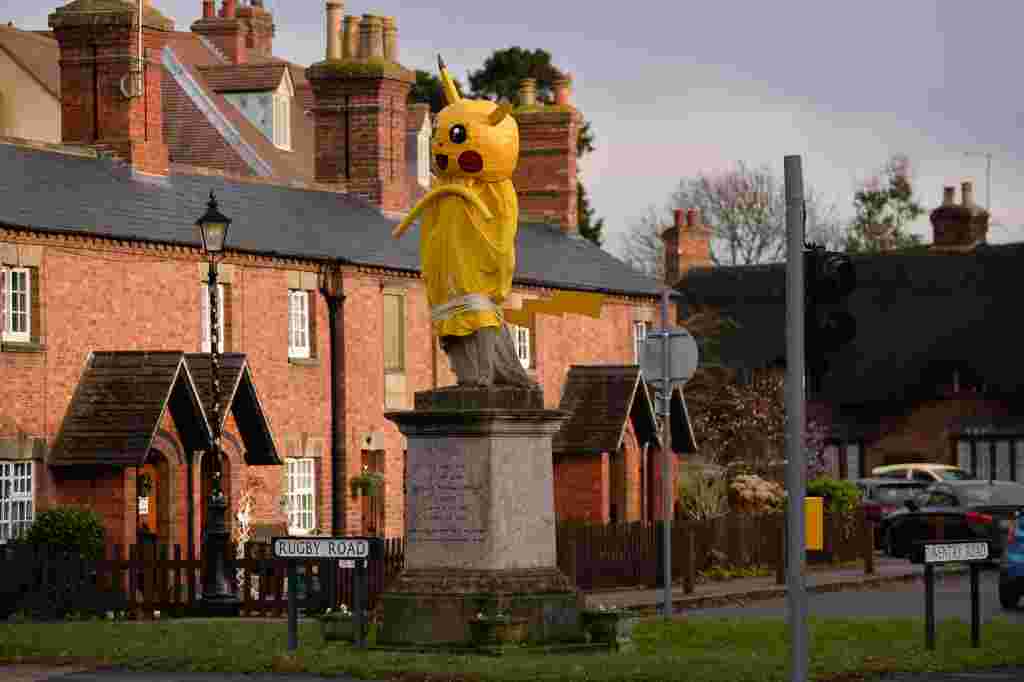 A giant Pikachu statue has appeared in the village of Dunchurch, Rugby where Christmas pranksters have again struck this year, following on a tradition, thought to date back to the 1970's, of giving the dreary statue of Lord John Scott a festive makeover.  See News Team story NTISTATUE; A town has been left mystified after waking to find pranksters covered their statue in a massive PIKACHU. Locals were scratching their heads after finding the 7ft (1.7m) yellow Pokemon draped over the monument to Lord John Scott on Saturday (10/12). Hilarious pictures show the critter covering the 19th century Scottish MP and Grenadier Guards officer in Dunchurch, Warks. Jonathon Westley, 52, said: "I couldn't believe it when I saw it, I had to double take.