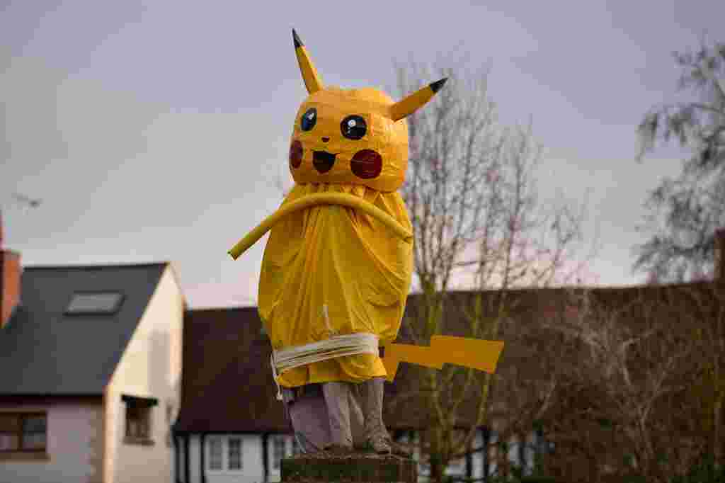 A giant Pikachu statue has appeared in the village of Dunchurch, Rugby where Christmas pranksters have again struck this year, following on a tradition, thought to date back to the 1970's, of giving the dreary statue of Lord John Scott a festive makeover.  See News Team story NTISTATUE; A town has been left mystified after waking to find pranksters covered their statue in a massive PIKACHU. Locals were scratching their heads after finding the 7ft (1.7m) yellow Pokemon draped over the monument to Lord John Scott on Saturday (10/12). Hilarious pictures show the critter covering the 19th century Scottish MP and Grenadier Guards officer in Dunchurch, Warks. Jonathon Westley, 52, said: "I couldn't believe it when I saw it, I had to double take.