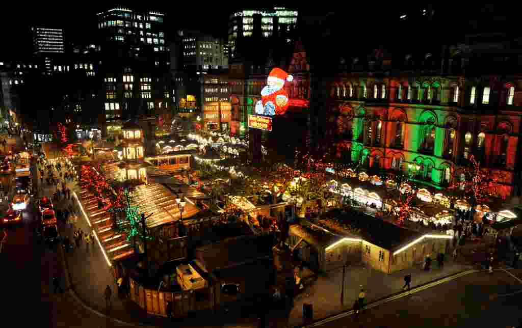 Christmas Market in Albert Square, Manchester.  See SWNS story SWXMAS.  It's the most wonderful time of the year - time to wrap up warm, drink steaming hot drinks and find unique gifts for your loved ones.  And where better to stock up on festive cheer than one of the hundreds of amazing Christmas markets located in some of the most scenic settings, in towns and cities over the festive period. From Big Wheels, to tiny trinkets these winter wonderlands have something for everybody including beer halls, ice rinks and carousels.